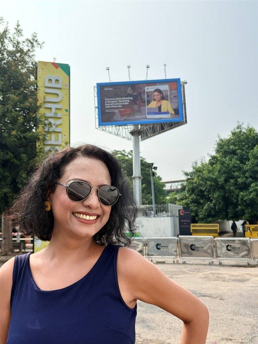 Vijayshree Kalani with her billboard behind her
